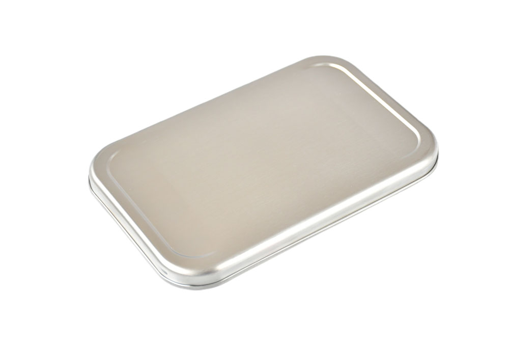 Angled view Stainless steel lid for lunch box – shiny replacement lid made of stainless steel on a white background